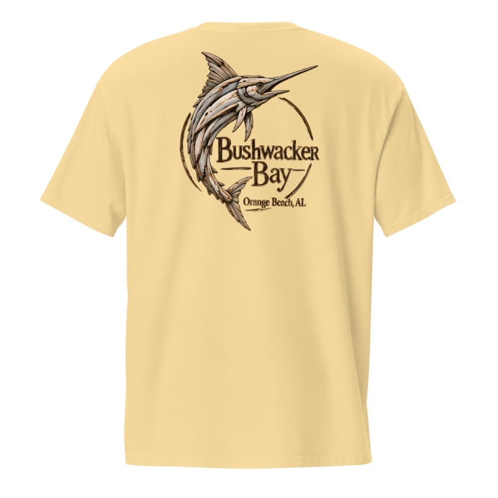 The back of a Bushwacker Bay tee printed with a blue marlin rendered entirely in weathered grey driftwood, curved around a ring lettered Bushwacker Bay, Orange Beach, AL